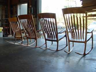 Three rocking chairs different sizes.